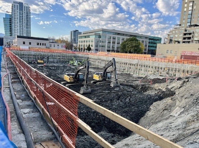 This is the hole being dug for the underground parking for the UBCO tower, forcing tenants to move out of the low white building across the street from it.