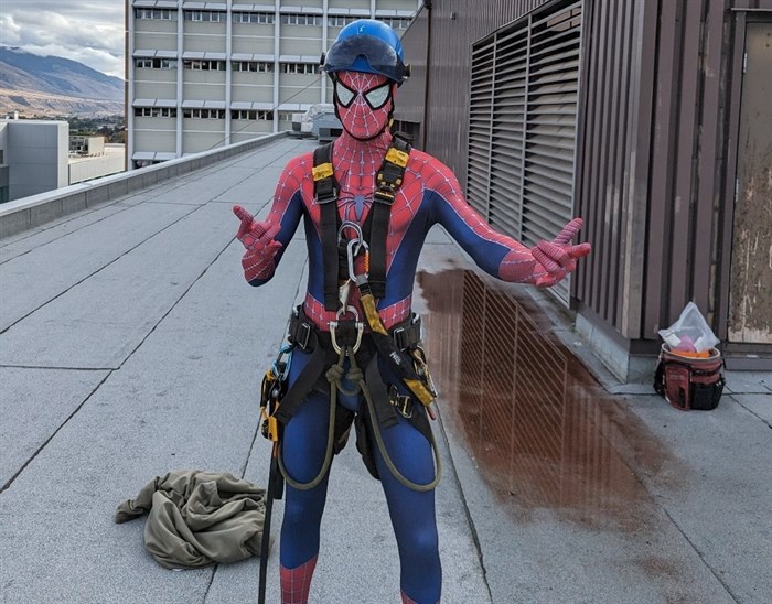 A Kamloops rope access technician Justin Kamata wears a costume while standing on the roof of Royal Inland Hospital.