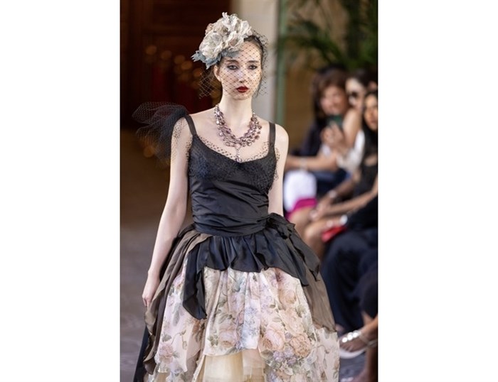 A model wearing jewelry from Carolily in West Kelowna walks the runway at Paris Fashion Week.