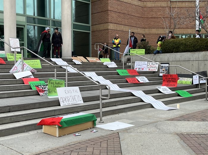The scroll of the names of civilian casualties compiled by UBCO students rolled down the courthouse steps.