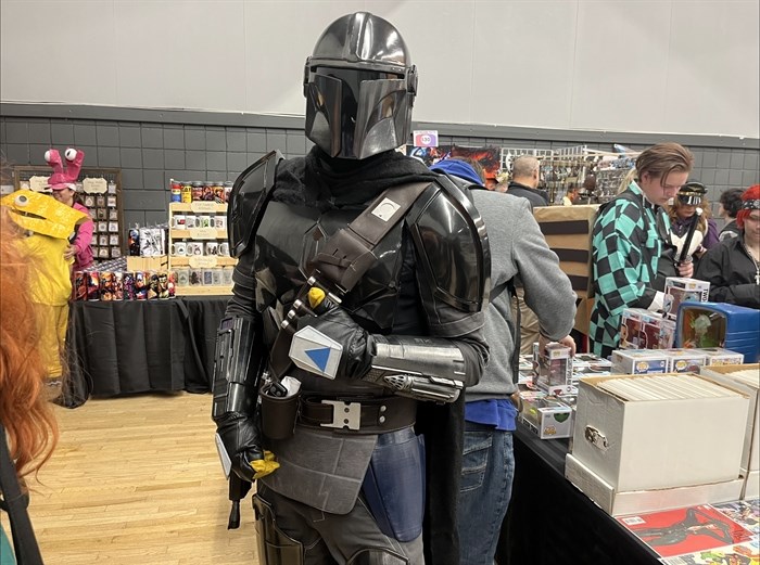 A cosplayer geared-up in a $1200 Star Wars Mandalorian costume.