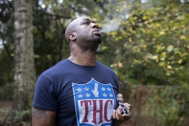 Former NFL tight end Boo Williams smokes medical marijuana at his home in Picayune, Miss., Wednesday, Nov. 15, 2023. Williams needs surgery, medicine and doctors to make the pain subside from injuries he endured during his football career. But he can't afford any of it. The 44-year-old was recently awarded $5,000 a month by the NFL's disability benefit plan. But Williams said the plan and the league have repeatedly mishandled his claims and should really have paid him $500,000 or more over the past 14 years. 