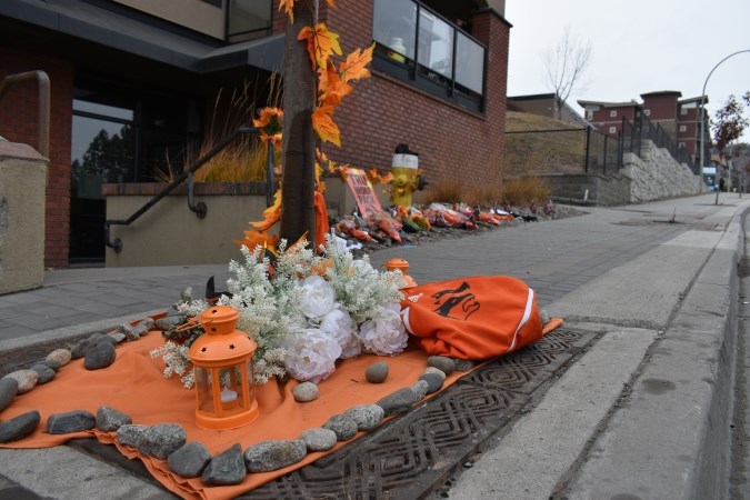 The memorial for McInnis lines the sidewalk near the crash site, just across the road from Thompson Rivers University.