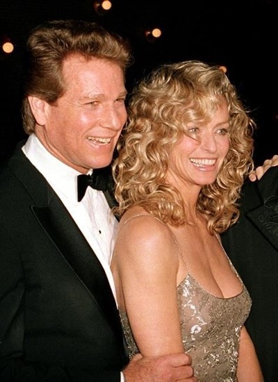 FILE - Ryan O'Neal, left, and Farrah Fawcett are shown at a premiere March 5, 1989.