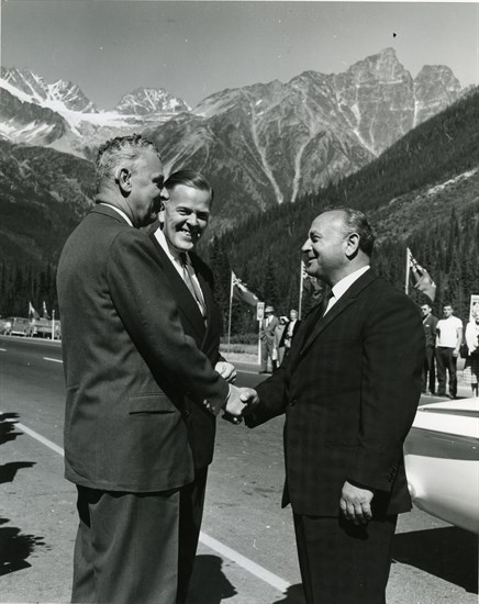 Ceremony to mark completion of the Trans Canada Highway at Rogers Pass, September 3, 1962. Three men shaking hands (left to right): Prime Minister John Diefenbaker, M.P. Davie Fulton, B.C. Minister of Transportation Phil Gaglardi.