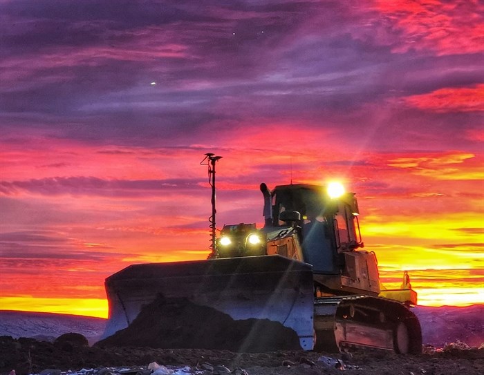 This photo shows a sunrise and stars over a work site and bulldozer near Kamloops. 