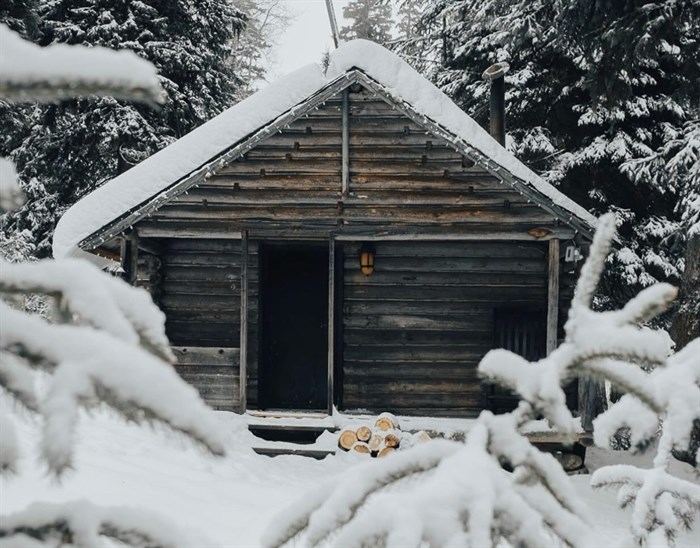 This photo of a snowy cabin at Chute Lake Lodge in Penticton brings cosy, winter vibes. 