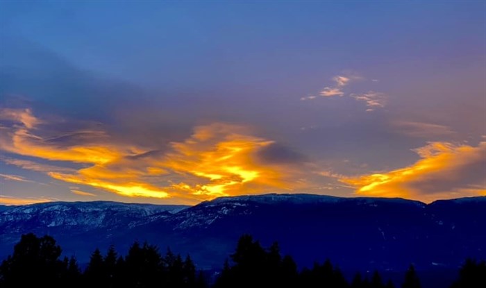 Swirls of golden light over the mountains are pictured in the Shuswap. 