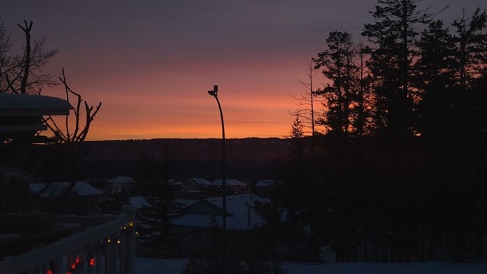 The sun is setting over Logan Lake. 