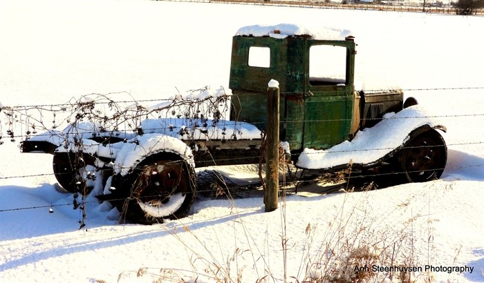 An old automobile sit in a snowy field in the Shuswap. 