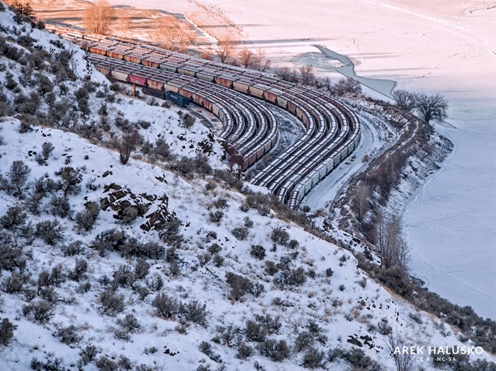 Several rows of trains covered in snow snaked along the river in Kamloops. 