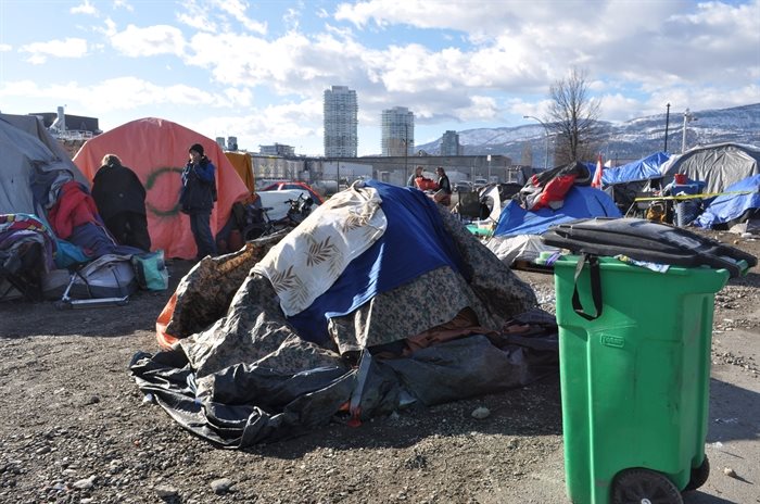 Layers of blankets and tarps are thrown over tents in efforts to keep living quarters dry, and mould-free.