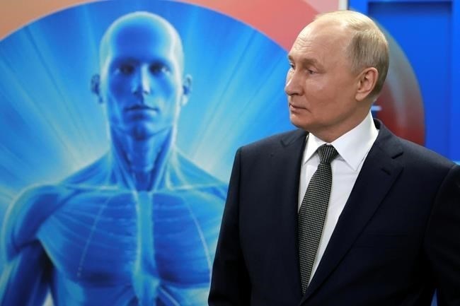 Russian President Vladimir Putin listens an explanation while visiting the Center for Diagnostics and Telemedicine in Moscow, Russia, Wednesday, Feb. 14, 2024.