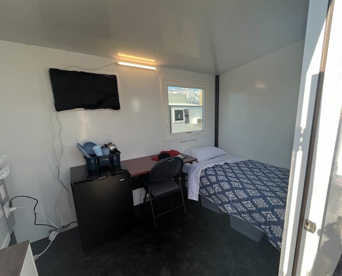 Each unit includes two storage shelves, a bed, a dresser, a mini-fridge, a desk, a chair and a heating and cooling unit. 