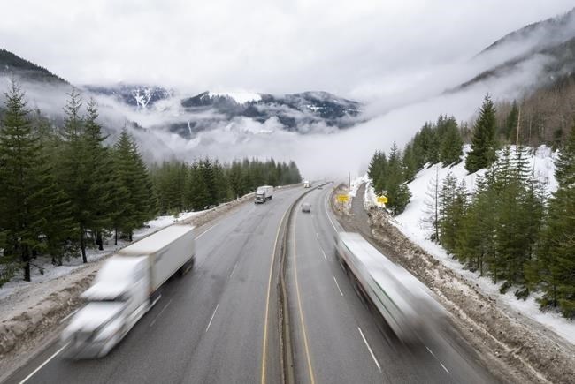 Heavy snowfall and winter storm conditions have shut down high-elevation stretches of a pair of major highways in the British Columbia Interior. Vehicles drive along the Coquihalla Highway, Wednesday, Jan. 19, 2022.