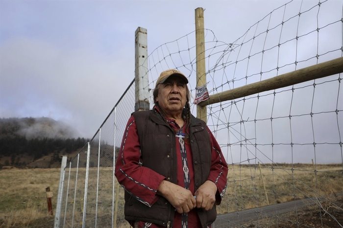 Dixon Terbasket, a syilx Okanagan wildlife technician with the Okanagan Nation Alliance from the Lower Similkameen Indian Band, stands outside of a fenced-off cherry orchard expansion site near Kelowna, British Columbia on Dec. 7, 2023. Terbasket and other conservation experts are concerned the cherry orchard