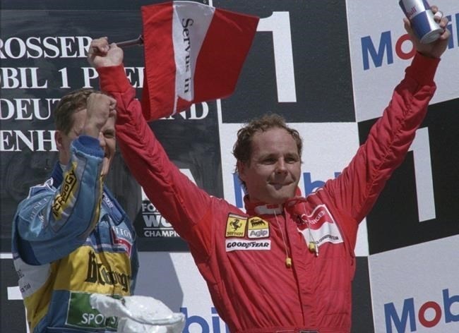 FILE - Michael Schumacher, the German winner of the German F1 Grand Prix, left, celebrates on the podium with third-placed Gerhard Berger of Austria, waving his national flag in Hockenheim, Germany, Sunday July 30, 1995. British police said Monday, March 4, 2024, that they have recovered a Ferrari stolen from Formula One driver Gerhard Berger in Italy almost three decades ago. The red Ferrari F512M was one of two sports cars taken while their drivers were in Imola, Italy for the San Marino Grand Prix in April 1995.