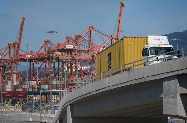 A new report finds that rising costs in trucking have overtaken the driver shortage as the biggest concern for employers in the sector. A transport truck carries a cargo container from the Centerm Container Terminal at port in Vancouver, on Friday, July 14, 2023.