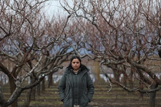 Jennifer Deol, the co-owner of There and Back Again Farms, stands near the farm’s peach orchard in Kelowna, B.C., on Tuesday, March 5, 2024. B.C. farmers are predicting at least a 90 per cent loss of this summer's harvest of fruit including peaches, apricots and nectarines.