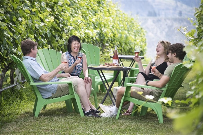 Group sitting in River Stone Winery's vineyard