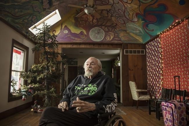 FILE - John Sinclair talks at the John Sinclair Foundation Café and Coffeeshop, Dec. 26, 2018, in Detroit. Sinclair, a poet, music producer and counterculture figure whose lengthy prison sentence after a series of small-time pot busts inspired a John Lennon song and a star-studded 1971 concert to free him, has died at age 82.