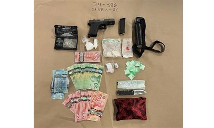 Weapons, drugs and cash seized by RCMP officers in Kamloops.