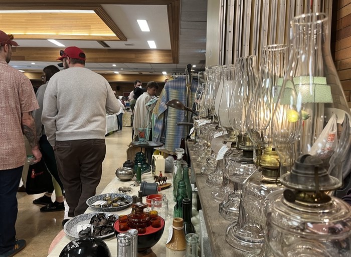 A row of lamps for sale along with some shoppers at the Okanagan Vintage Fair. 