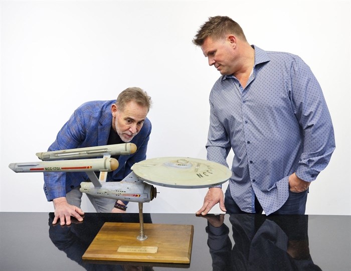 Joe Maddalena, executive vice president of Heritage Auctions, left, and Eugene “Rod” Roddenberry, the son of “Star Trek” creator Gene Roddenberry, view the recently recovered first model of the USS Enterprise at Heritage Auctions in Los Angeles, April 13, 2024. The model — used in the original “Star Trek” television series — has been returned to Eugene, decades after it went missing in the 1970s. 