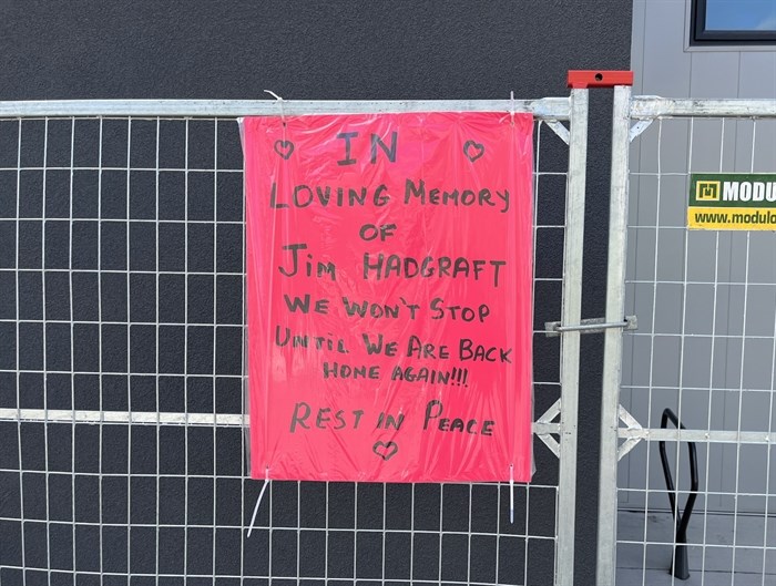 A memorial sign for Jim Hadgraft posted outside of Hadgraft Wilson Place.