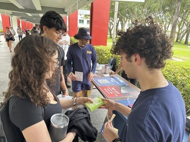 College students pass out Plan B to educate young voters at Florida Atlantic University on Thursday, April 11, 2024, in Boca Raton, Fla. Abortion and marijuana will be on Florida's November ballot, and these issues are critical issues for young voters.