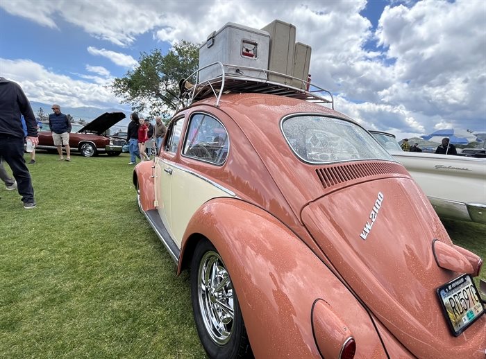 A 1961 Volkswagen Beetle fitted with some luggage on top. 