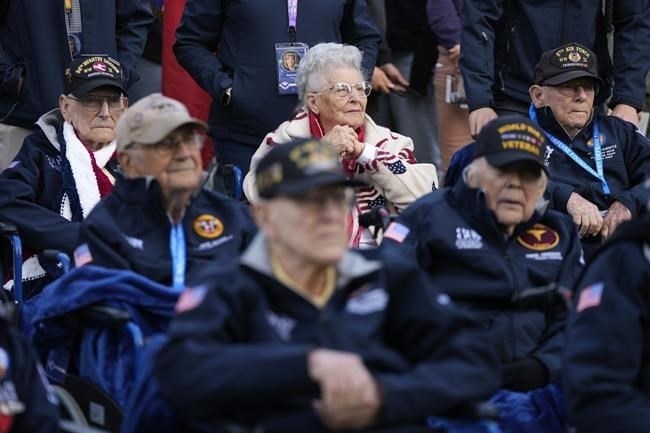 U.S. World War II veteran Anna Mae Krier, center rear, listens as she sits with other veterans during a service at the Normandy American Cemetery in Colleville-sur-Mer, France, Tuesday, June 4, 2024. World War II veterans from across the United States as well as Britain and Canada are in Normandy this week to mark 80 years since the D-Day landings that helped lead to Hitler's defeat. 