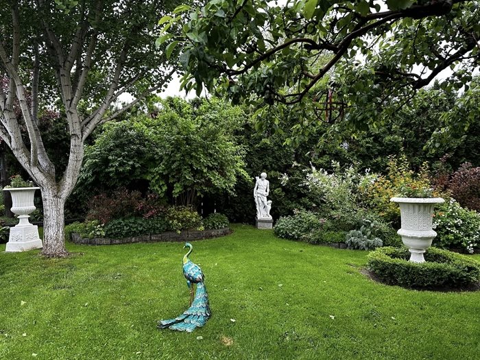 Statues and a lawn ornament decorate this blooming garden in Kamloops. 