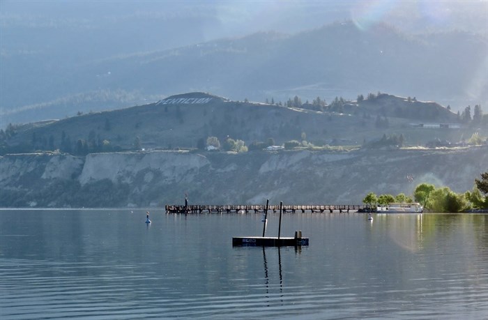 The Penticton sign can be seen on the hillside overlooking Okanagan Lake.