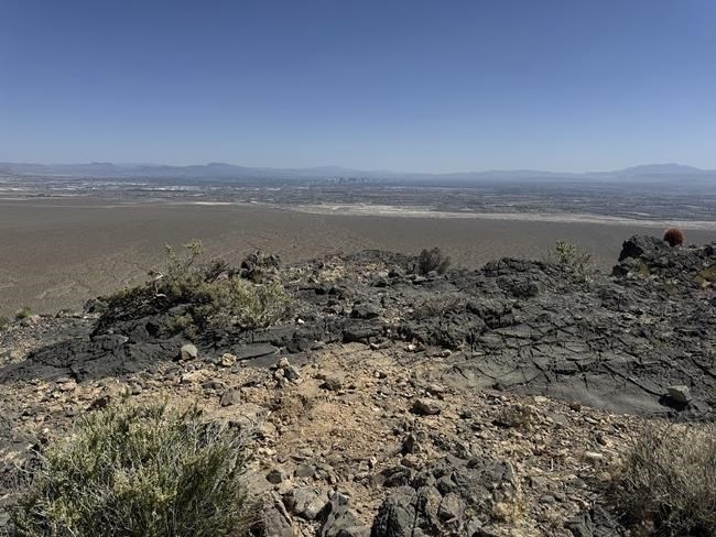 This photo provided by Las Vegas Metropolitan Police Department, the mysterious Monolith is removed on Thursday, June 20, 2024 in Gass Peak, part of the vast Desert National Wildlife Refuge in Nevada. A strange monolith found jutting out of the rocks in a remote mountain range near Las Vegas has been taken down by authorities.