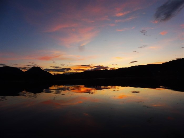 Pinantan Lake near Kamloops reflects pink clouds. 