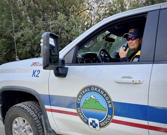 A search and rescue member in a pickup truck. 