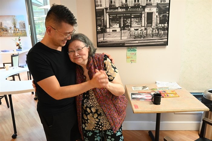 Eric Li and his mother, May Tsoi, at the Broadway Lodge, where Tsoi is a resident. Tsoi had been sitting and doing artwork when her son walked over. She lit up and stood to greet him.