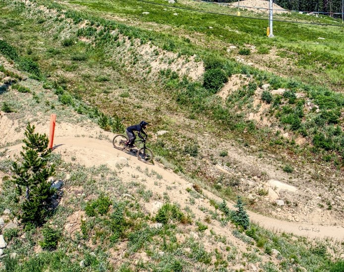 A mountain biker is seen from a chairlift at Big White Ski Resort. 