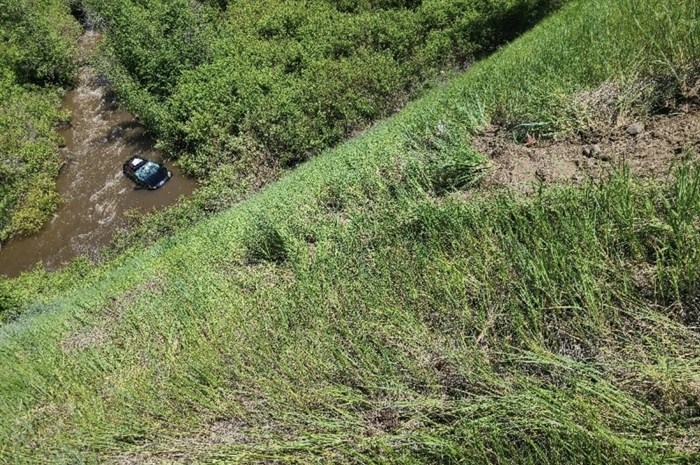 The car in Hat Creek in the top left and the steep embankment off Highway 99 in June 2022. 