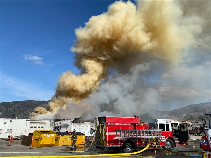 Firefighters battle a fire at an industrial manufacturing building at Stevens Road and Industrial Road in West Kelowna Wednesday, Aug. 21, 2024.