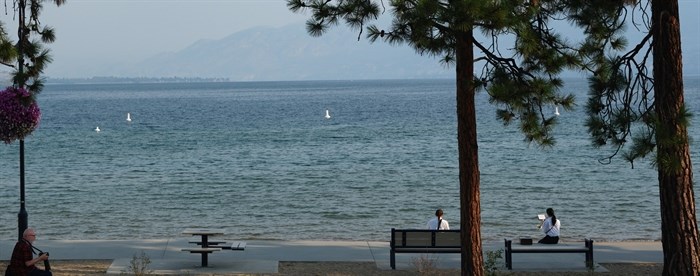 People relax on the Okanagan lakeshore in Penticton