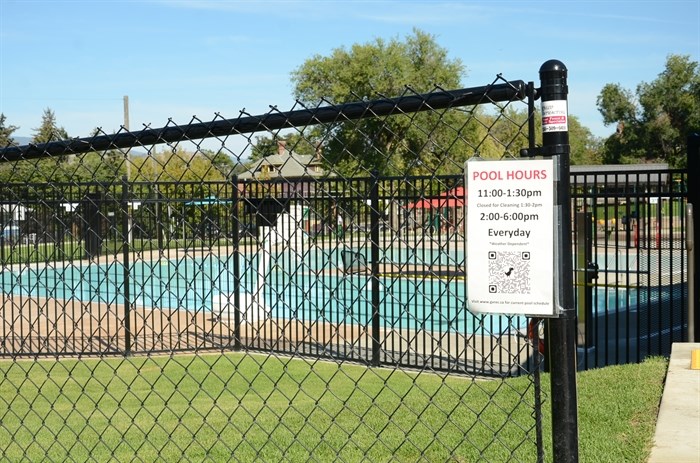 The new pool is located behind a large black fence.