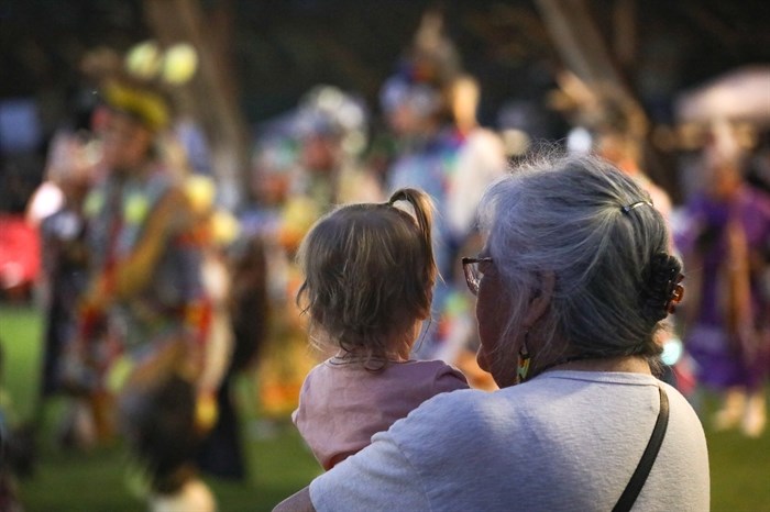 Community members watch the grand entry for the 2024 Similkameen Powwow of Champions during its opening night on Aug. 30.

