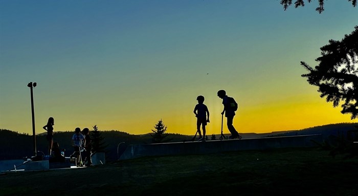 Young people enjoy a skate park in Logan Lake on a late summer evening. 