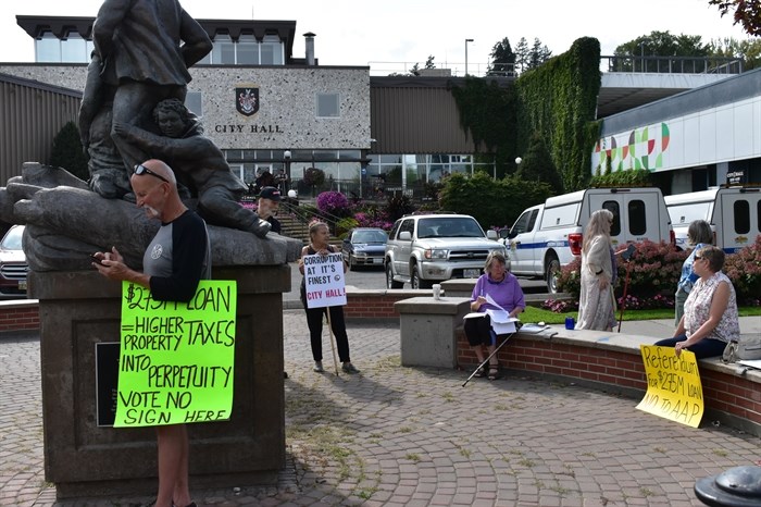 A group of protesters voiced their mistrust of Kamloops city hall as the deadline for the Alternative Approval Process approached Friday afternoon, Sept. 13, 2024.