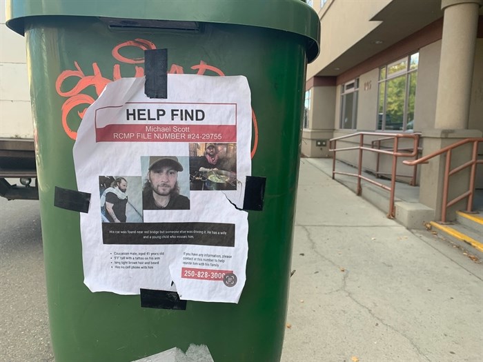 A missing poster for deceased Michael Scott is taped to a bin in downtown Kamloops. 