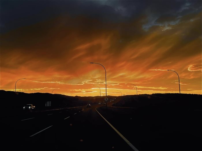 The setting sun lights up Highway 1 on an evening in Kamloops. 