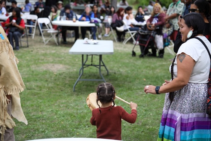 A young drummer plays at the syilx Nation’s 2024 salmon feast and celebration at sx???x??nitk? (Okanagan Falls) on Sept. 22.