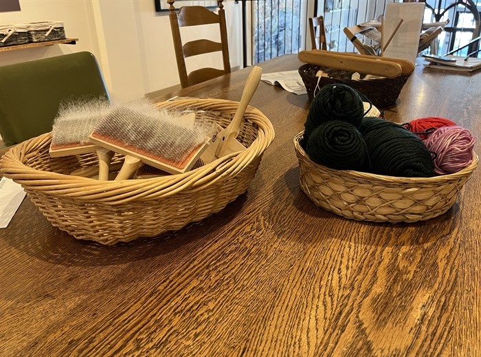 Baskets of wool and tools sit on a table at Kamloops Museum and Archives. 